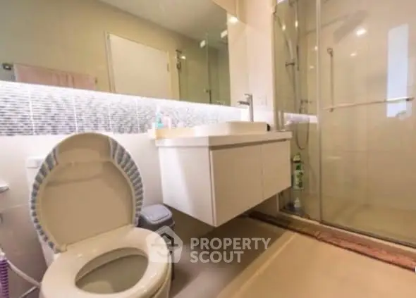 Modern bathroom with glass shower and sleek vanity