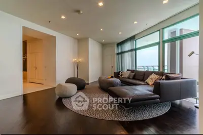 Luxurious modern living room with stylish furniture and large windows offering stunning views.