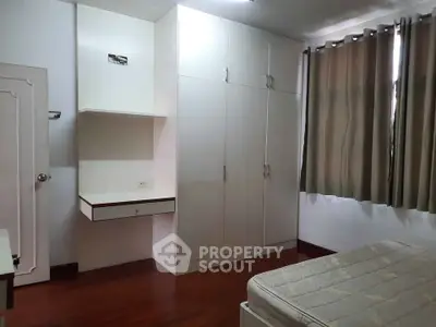 Spacious bedroom with built-in wardrobe and natural light