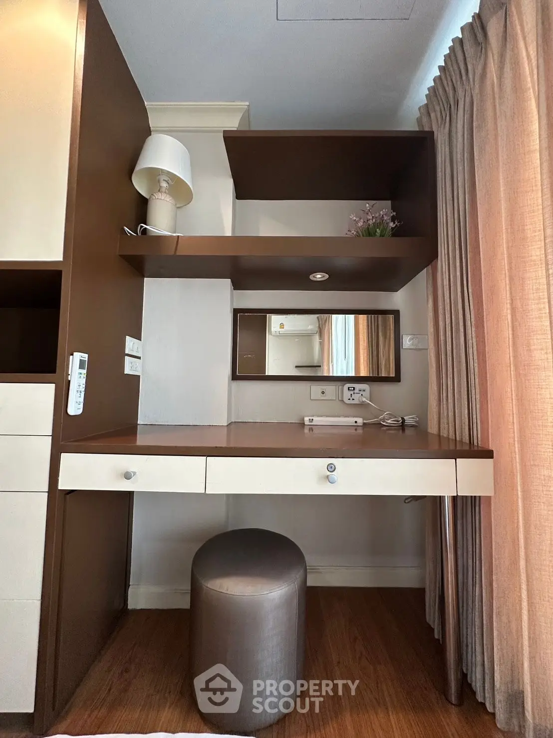 Stylish study nook with modern desk, shelves, and elegant decor in cozy apartment.