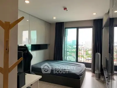 Modern bedroom with city view, featuring sleek design and ample natural light.