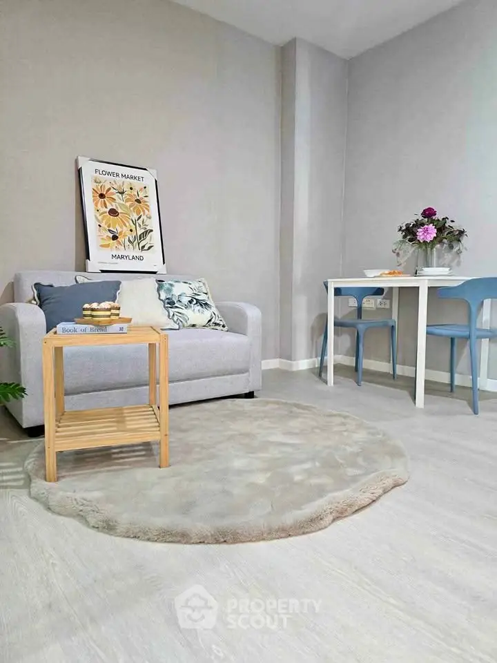 Charming living room with cozy sofa, stylish decor, and elegant dining area, perfect for modern living.