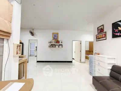 Spacious living room with modern decor and white tiled flooring