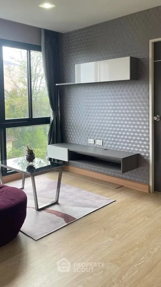 Modern living room with large window and stylish furniture in a contemporary apartment.