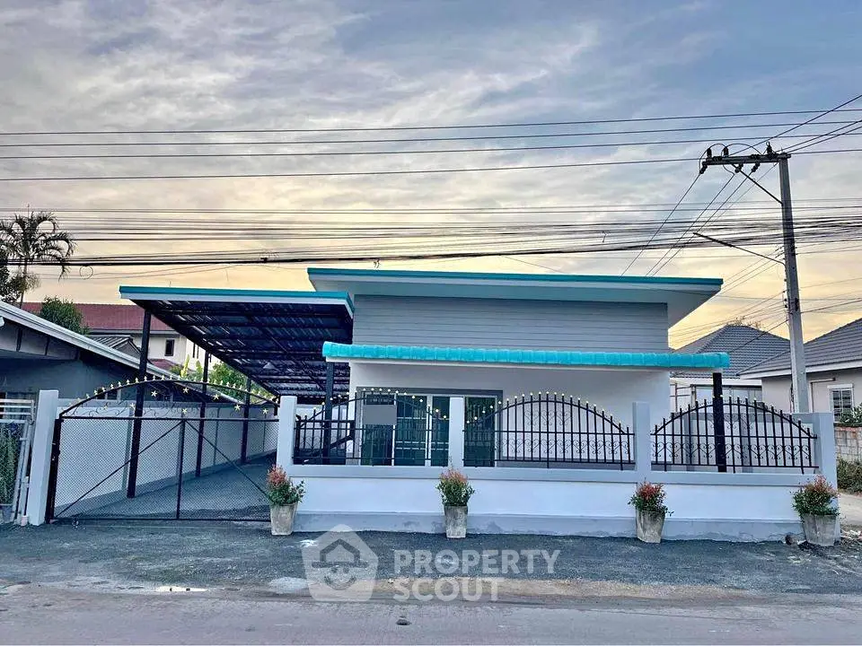 Charming single-story house with gated entrance and carport in a serene neighborhood.