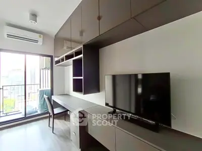Modern living room with sleek furniture and balcony view in a high-rise apartment.