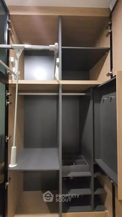 Spacious modern walk-in closet with sleek shelving and ample storage space.