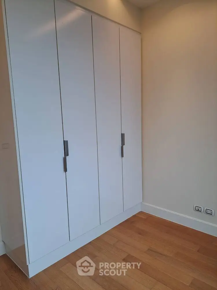 Modern built-in wardrobe with sleek design and wooden flooring