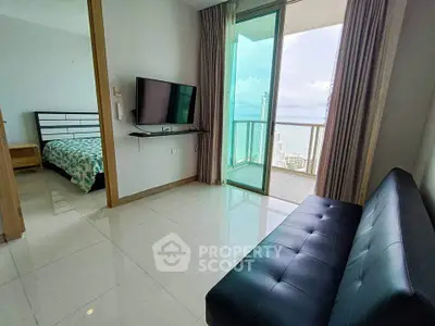 Modern apartment with balcony and city view, featuring sleek furnishings and natural light.