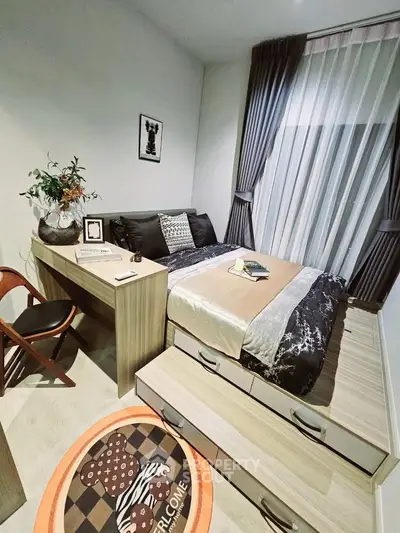 Cozy bedroom with modern decor, featuring a bed with storage drawers, desk, and elegant curtains.