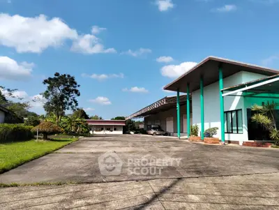 Spacious industrial property with large parking area and modern warehouse facilities.