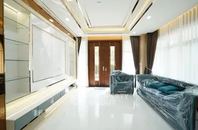 Luxurious modern living room with elegant sofas and large windows, perfect for relaxation and entertainment.