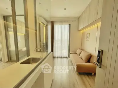 Modern living room with sleek design, featuring a cozy sofa and large window for natural light.