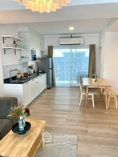 Modern open-plan living room and kitchen with wooden flooring and stylish decor