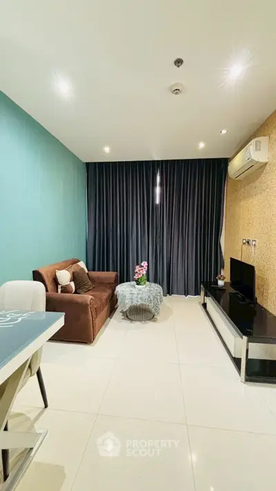 Modern living room with stylish decor and comfortable seating in a cozy apartment.