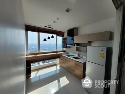 Modern kitchen with panoramic city view, sleek cabinetry, and natural light