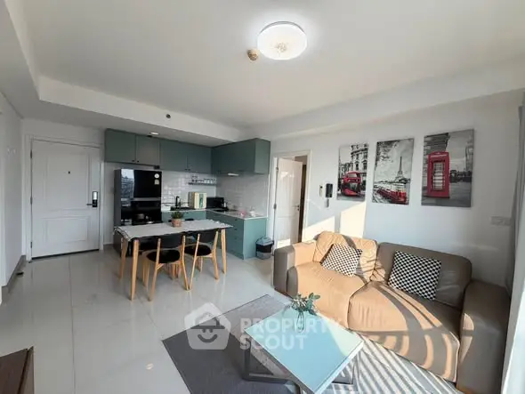 Modern open-plan living room and kitchen with stylish decor and ample natural light.