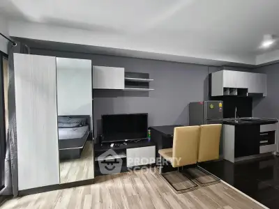 Modern studio apartment with sleek kitchen and cozy living area