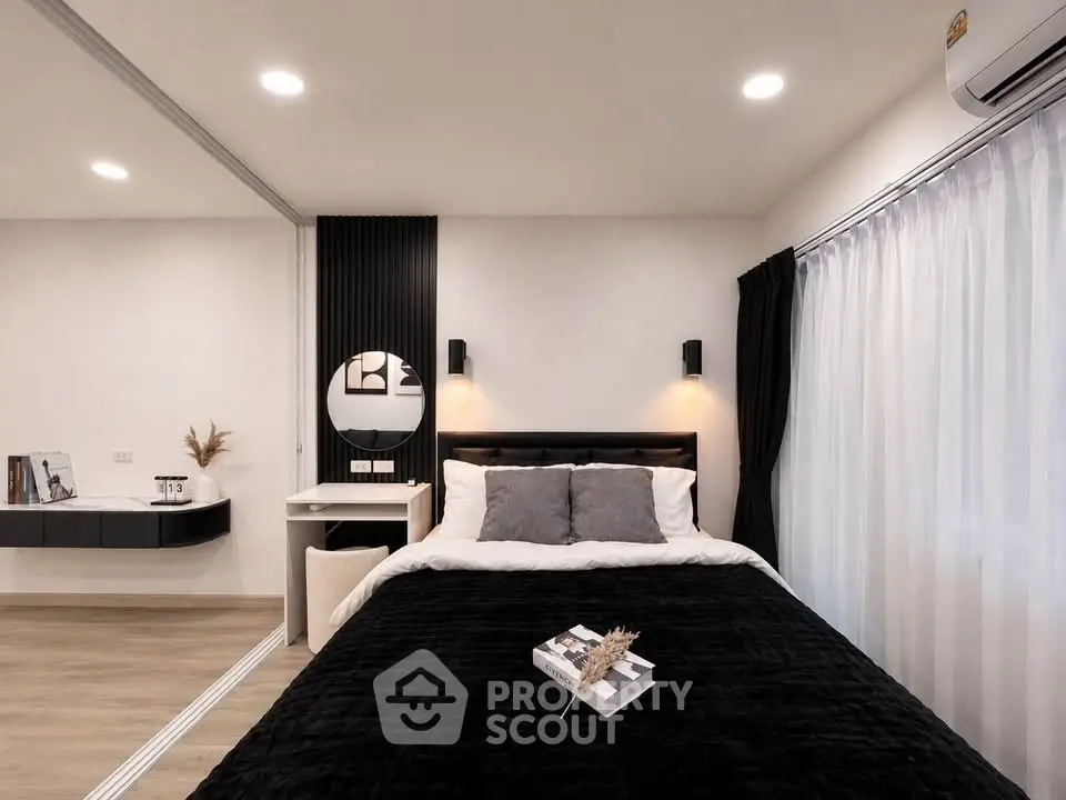 Modern bedroom with stylish decor and cozy ambiance, featuring a comfortable bed and elegant lighting.