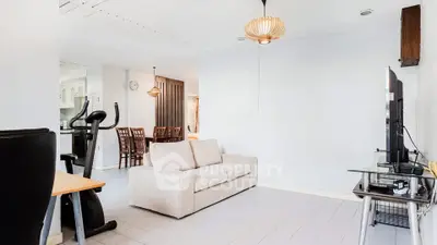 Spacious living room with modern decor and exercise equipment, perfect for relaxation and fitness.