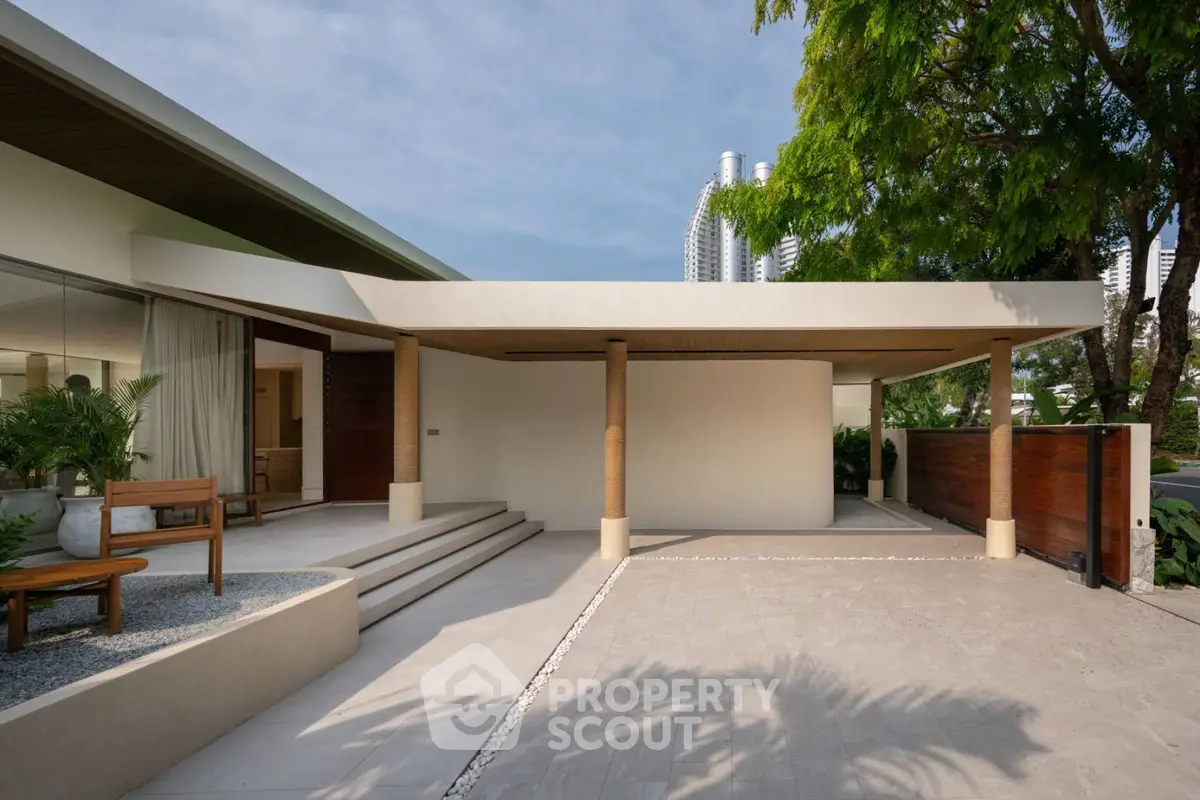 Modern architectural entrance with sleek design and lush greenery