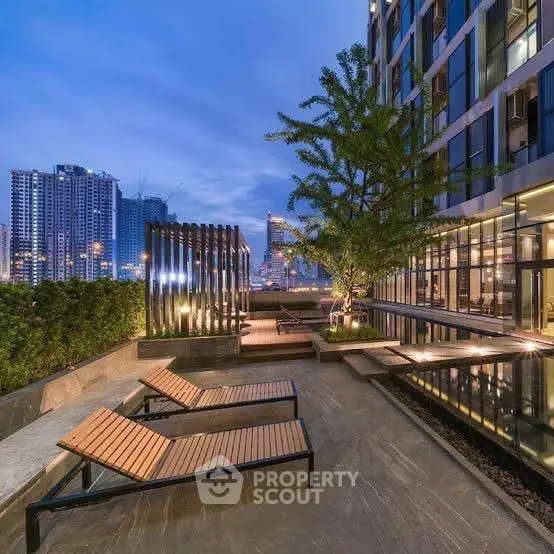 Luxurious rooftop terrace with stunning city skyline view and modern lounge chairs.