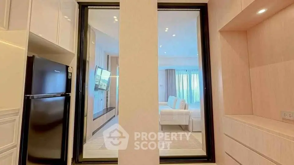 Modern open-plan kitchen and living room with sleek design and natural light.