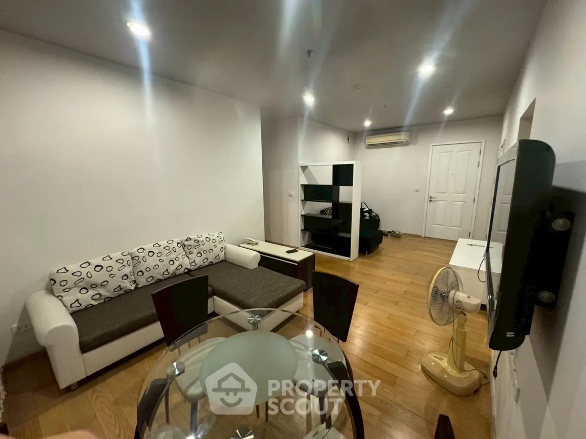 Spacious living room with modern furniture and wooden flooring