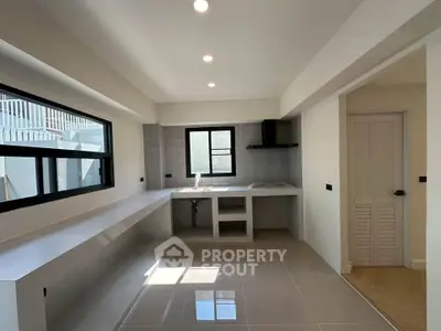 Spacious modern kitchen with sleek design and ample natural light