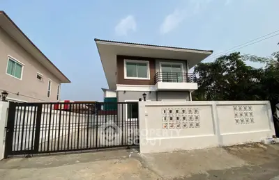 Modern two-story house with gated entrance and minimalist design