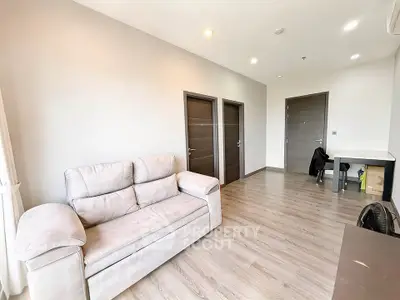 Spacious modern living room with elegant sofa and wooden flooring