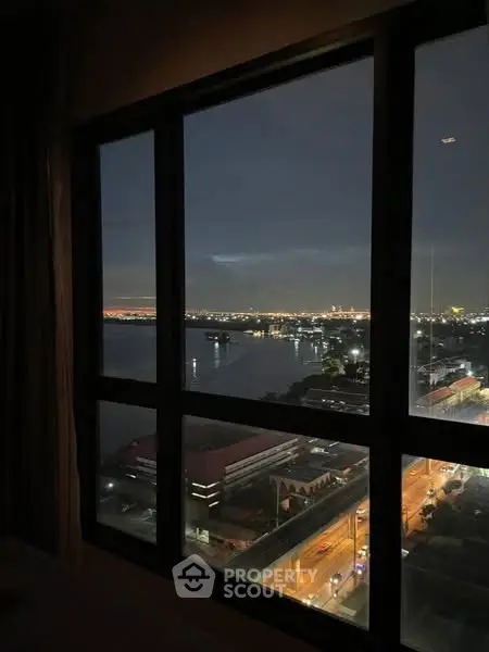 Stunning cityscape view from high-rise apartment window at night
