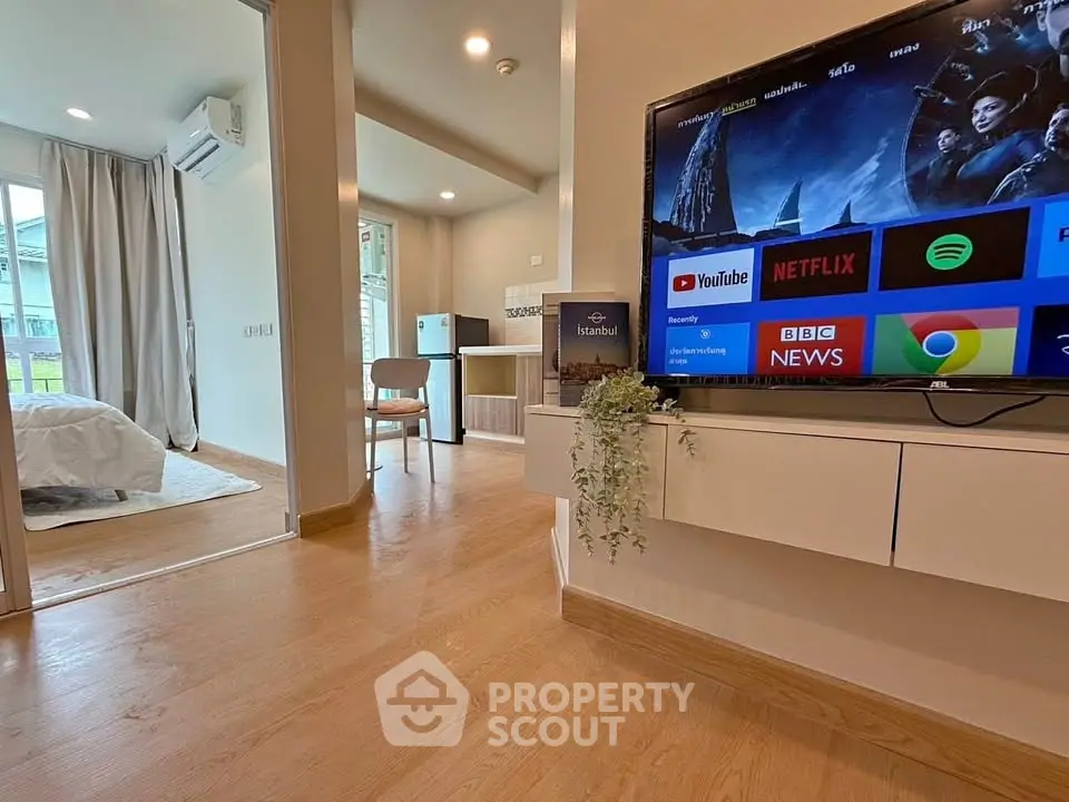 Modern apartment interior with smart TV and cozy bedroom view