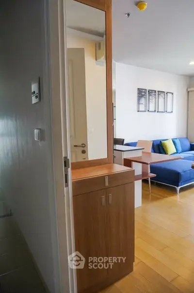 Modern living room with wooden flooring and stylish furniture in a cozy apartment.