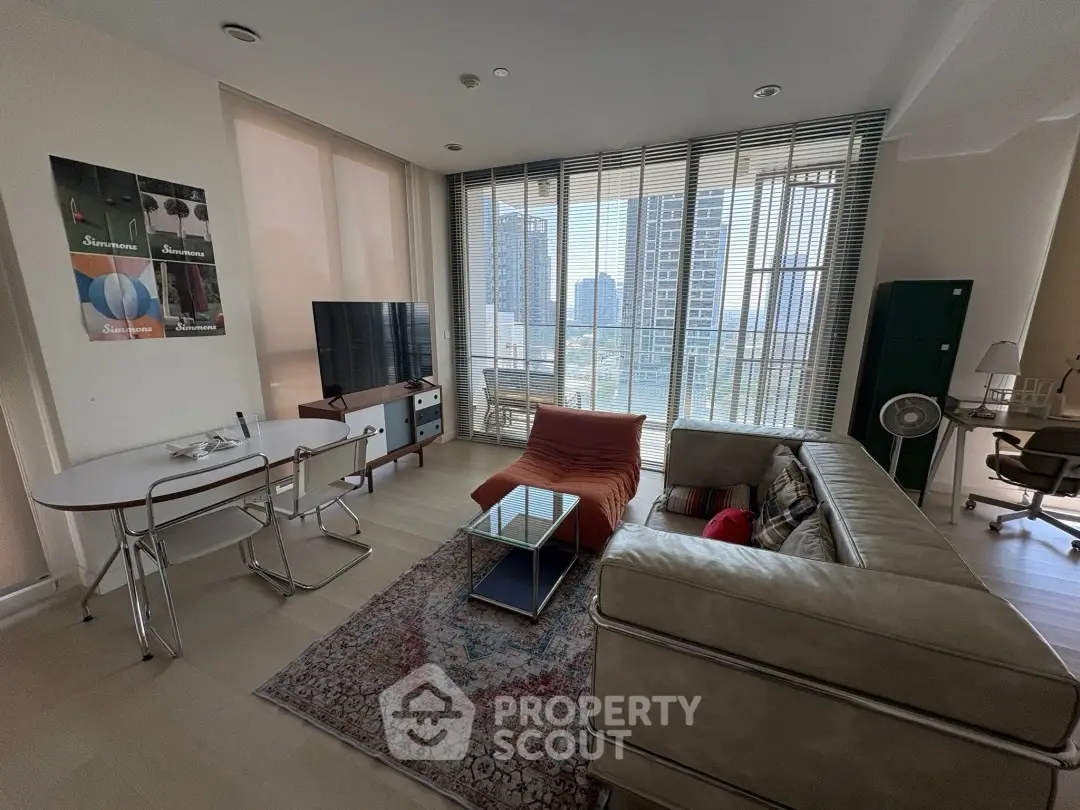 Modern living room with large windows, stylish furniture, and city view.