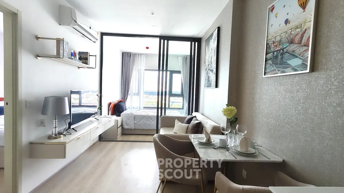 Modern open-plan living room with dining area and large windows offering stunning views.
