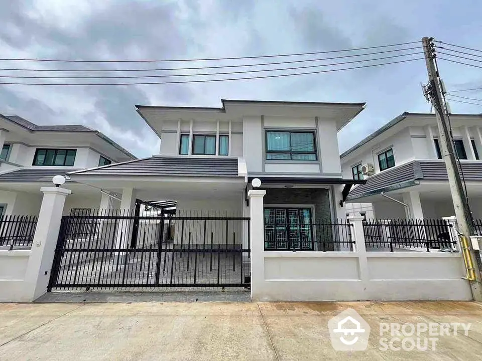 Modern two-story house with gated entrance and contemporary design