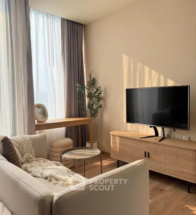 Modern living room with stylish furniture and large window, perfect for relaxation.