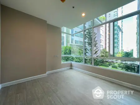 Spacious corner unit with large windows offering a great view in a modern apartment building.