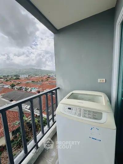 Charming balcony with scenic view and washing machine, perfect for urban living.