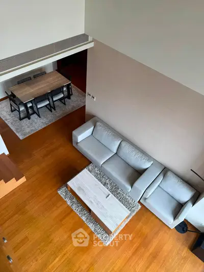 Spacious modern living room with elegant dining area and wooden flooring