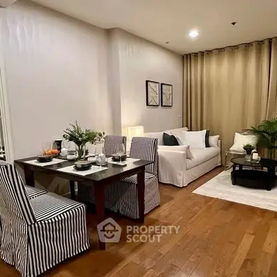 Chic modern living room with dining area, featuring elegant decor and cozy ambiance.