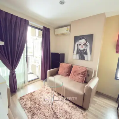 Chic living room with modern decor, cozy sofa, and balcony access in stylish apartment.