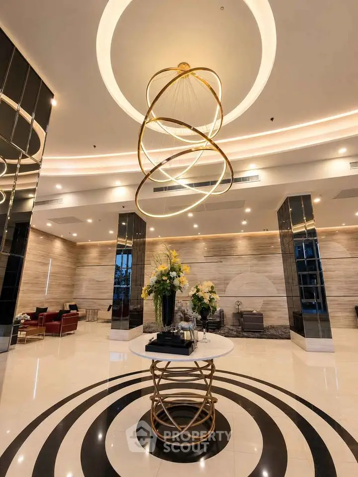 Luxurious lobby with modern chandelier and elegant decor in upscale building