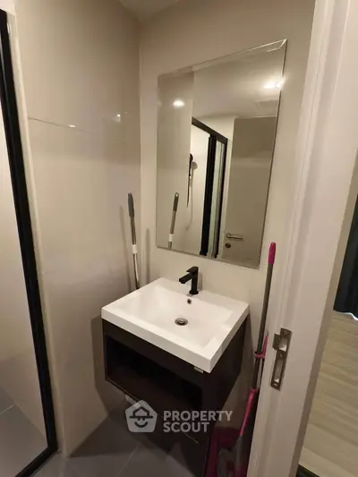 Modern bathroom with sleek sink and mirror in compact space