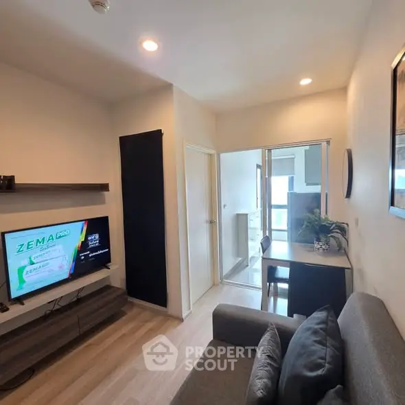 Modern living room with sleek furniture and TV, featuring a cozy ambiance and stylish decor.