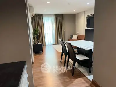 Spacious modern living room with dining area and natural light in a stylish apartment.