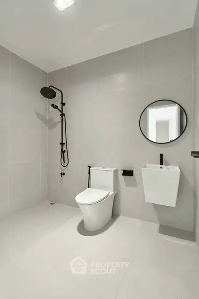 Modern minimalist bathroom with sleek fixtures and neutral tones.