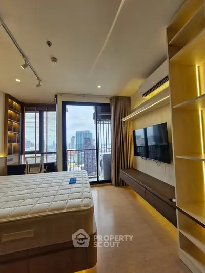Modern bedroom with city view, featuring built-in shelves and wall-mounted TV, perfect for urban living.