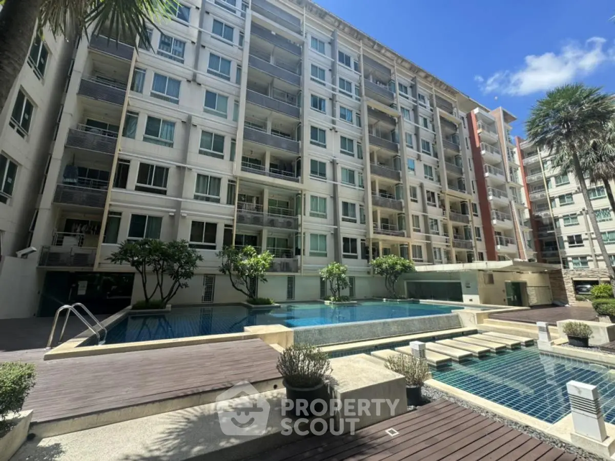 Modern condominium with pool and lush greenery, perfect for urban living.